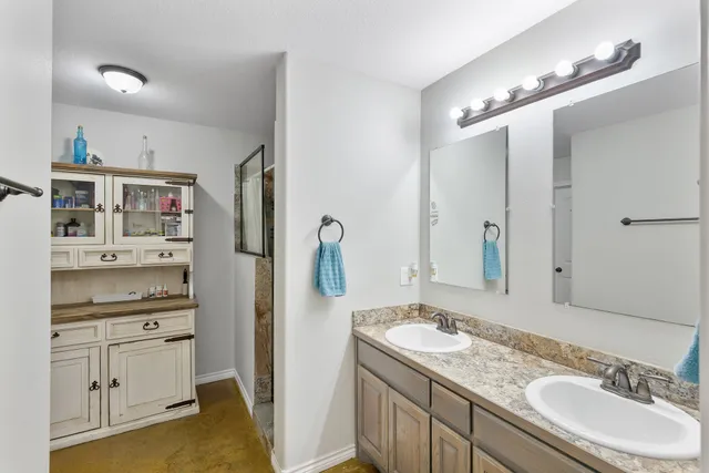 a bathroom with a granite countertop sink mirror and double