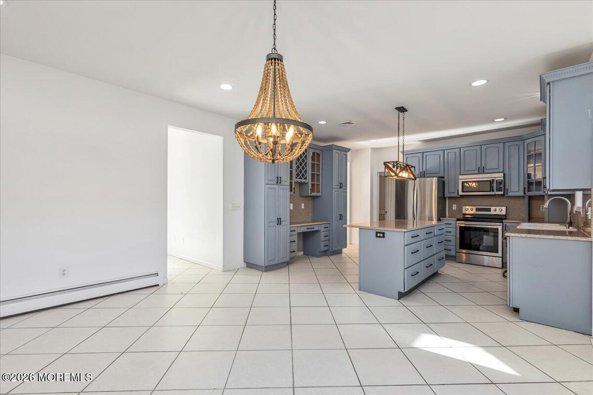 257 Ford Road Howell, NJ 07731 - Photo 14 of 45 a kitchen with stainless steel appliances kitchen island granite countertop a refrigerator and a stove top oven
