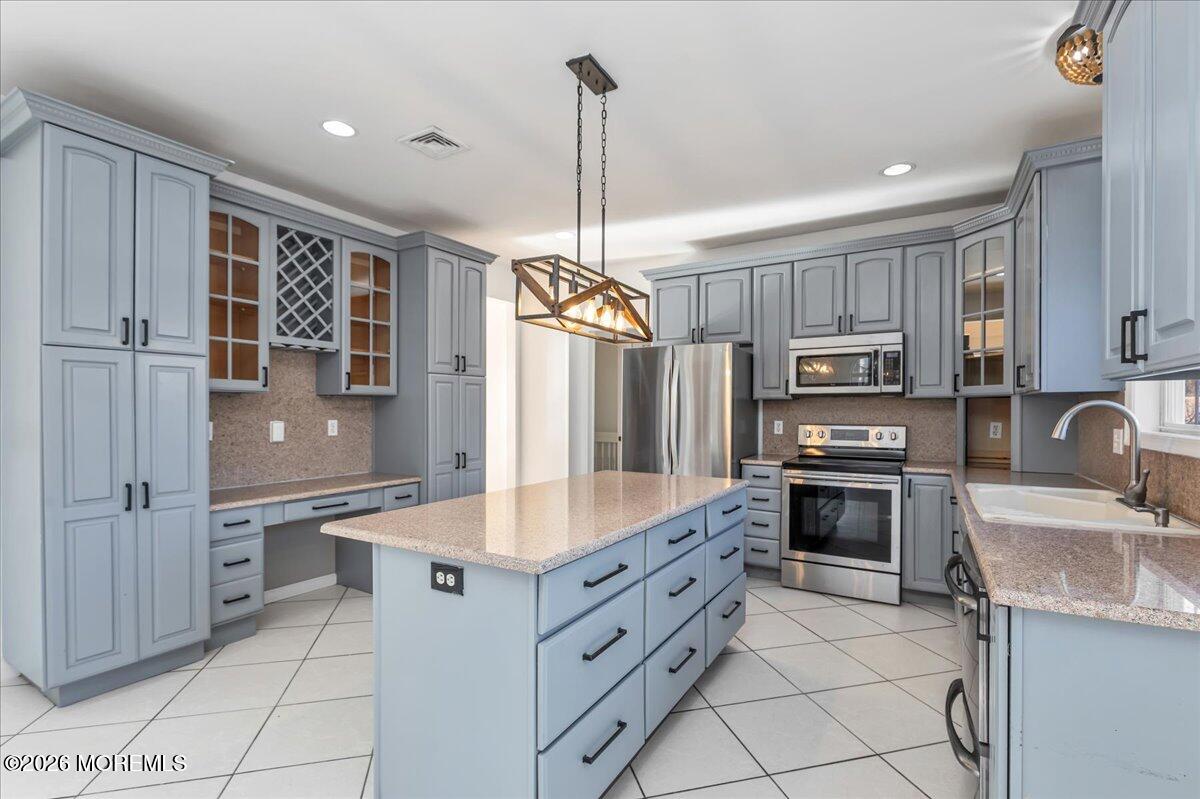 257 Ford Road Howell, NJ 07731 - Photo 15 of 45 a kitchen with stainless steel appliances granite countertop a sink stove and refrigerator