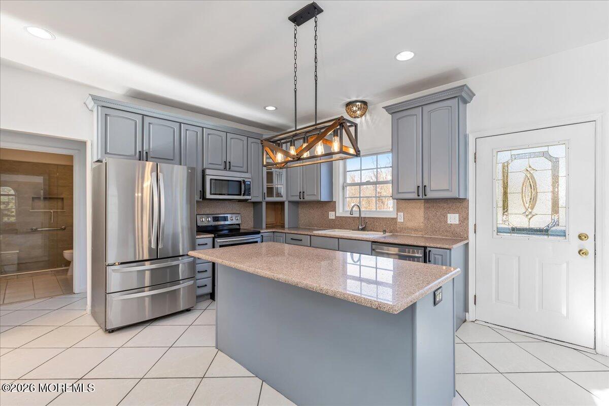 257 Ford Road Howell, NJ 07731 - Photo 16 of 45 a kitchen with stainless steel appliances granite countertop a refrigerator a stove a sink and a refrigerator