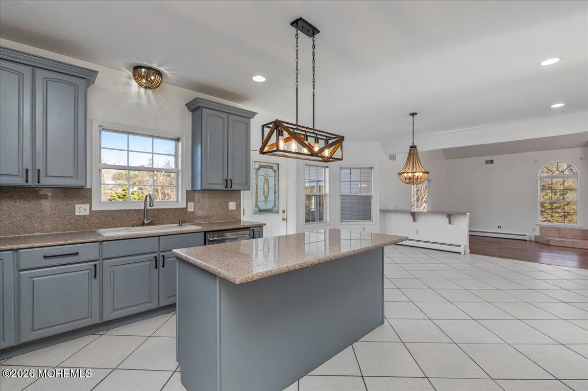 257 Ford Road Howell, NJ 07731 - Photo 17 of 45 a kitchen with granite countertop a sink a window and stainless steel appliances