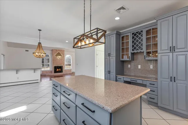 a kitchen with stainless steel appliances granite countertop a sink and a refrigerator