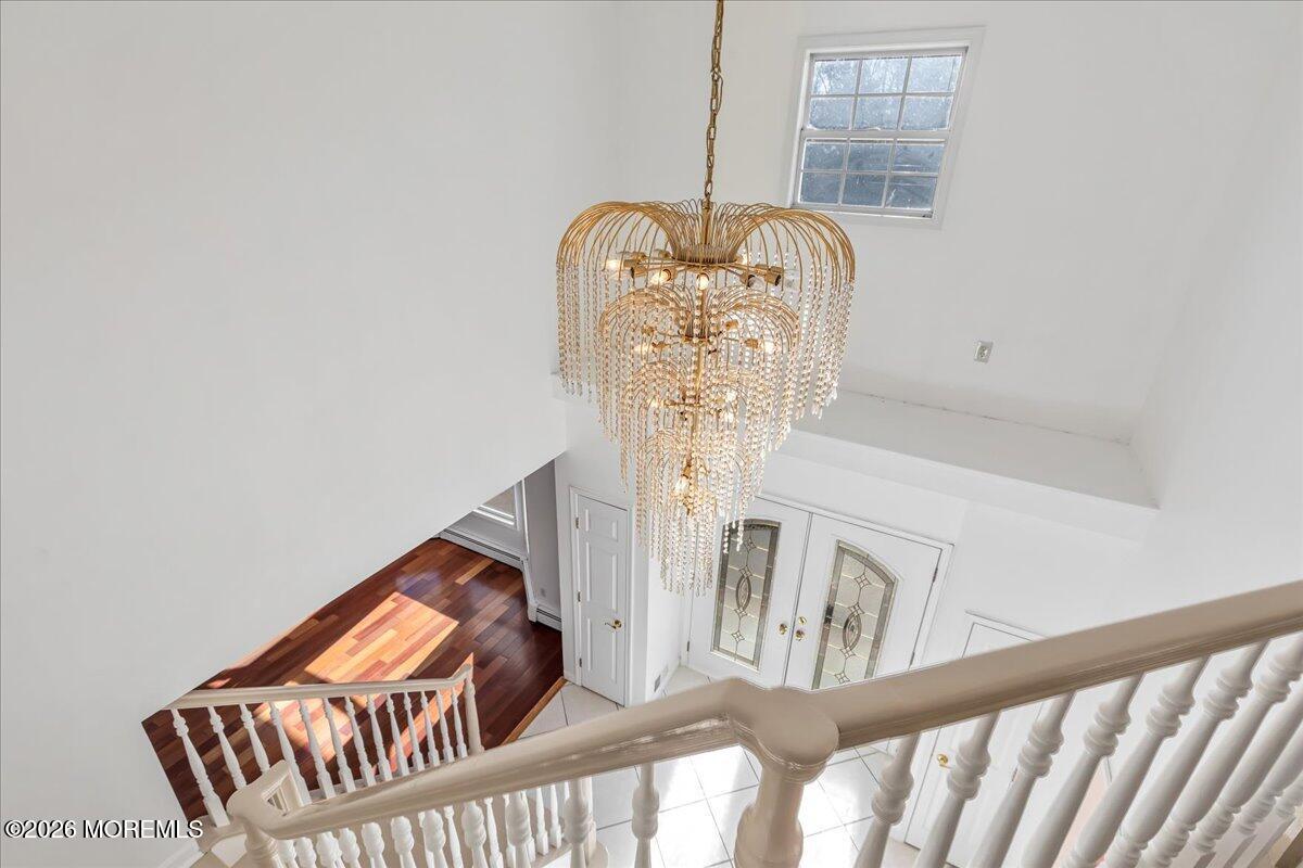 257 Ford Road Howell, NJ 07731 - Photo 26 of 45 a view of staircase with lots of frames on wall and a window