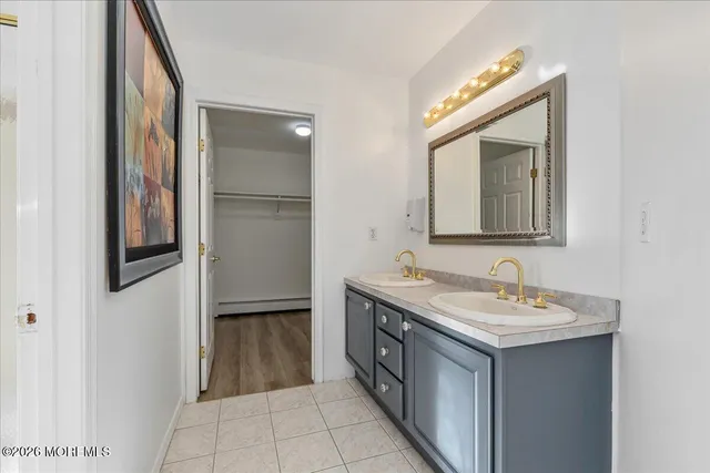 a bathroom with a double vanity sink and a mirror