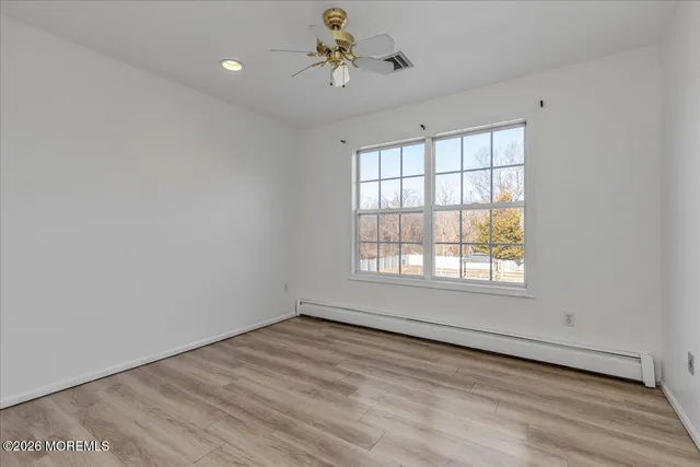 wooden floor in an empty room with a window