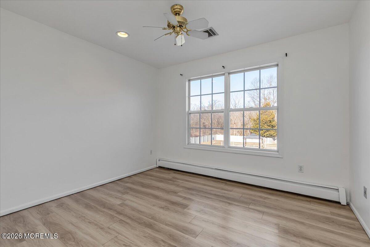 257 Ford Road Howell, NJ 07731 - Photo 33 of 45 wooden floor in an empty room with a window
