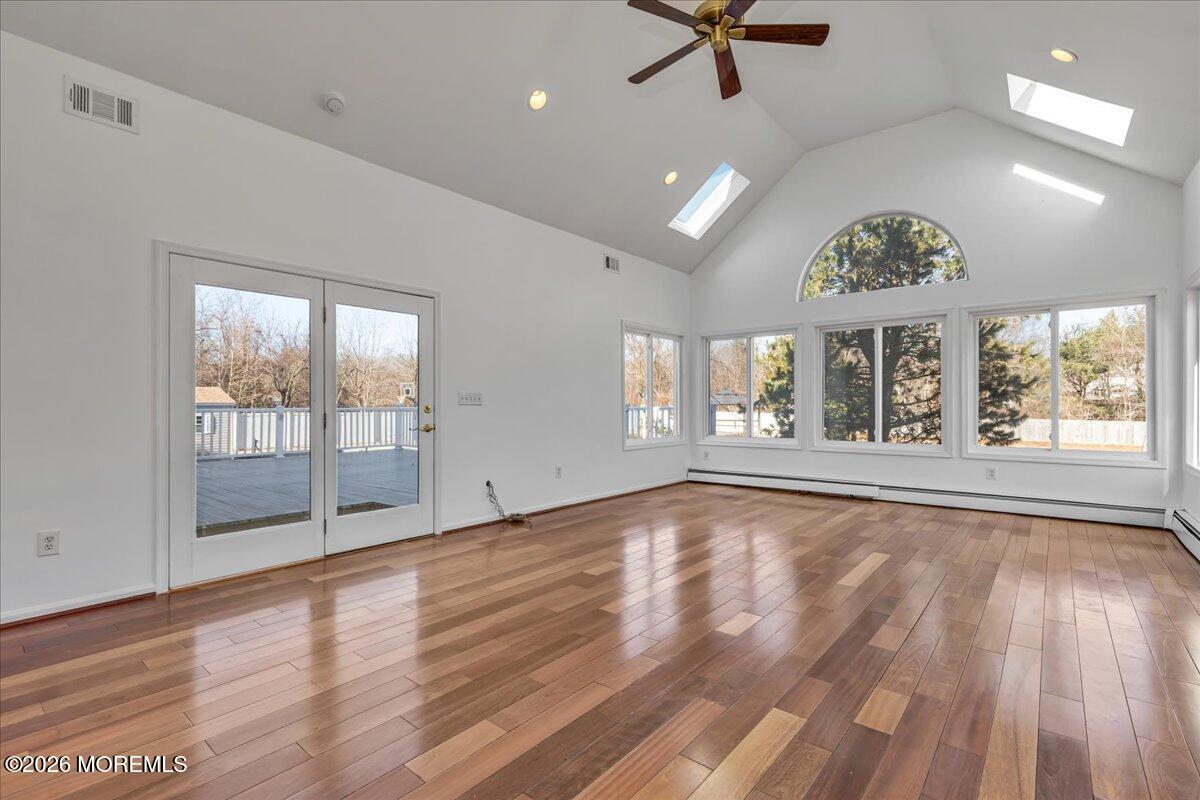 257 Ford Road Howell, NJ 07731 - Photo 10 of 45 a view of an empty room with a window and wooden floor