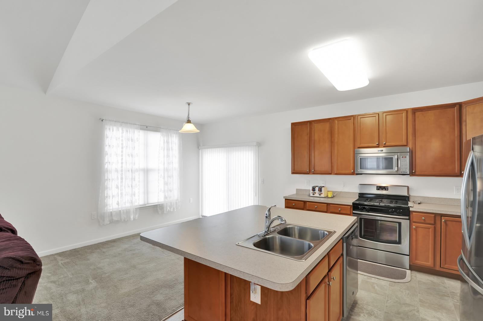 37 Spring Arbor Drive Middletown, DE 19709 - Photo 11 of 37 a kitchen that has a sink a stove and a microwave