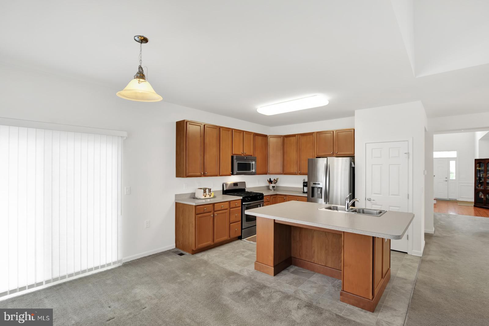 37 Spring Arbor Drive Middletown, DE 19709 - Photo 12 of 37 a kitchen with stainless steel appliances granite countertop a sink a stove and a refrigerator
