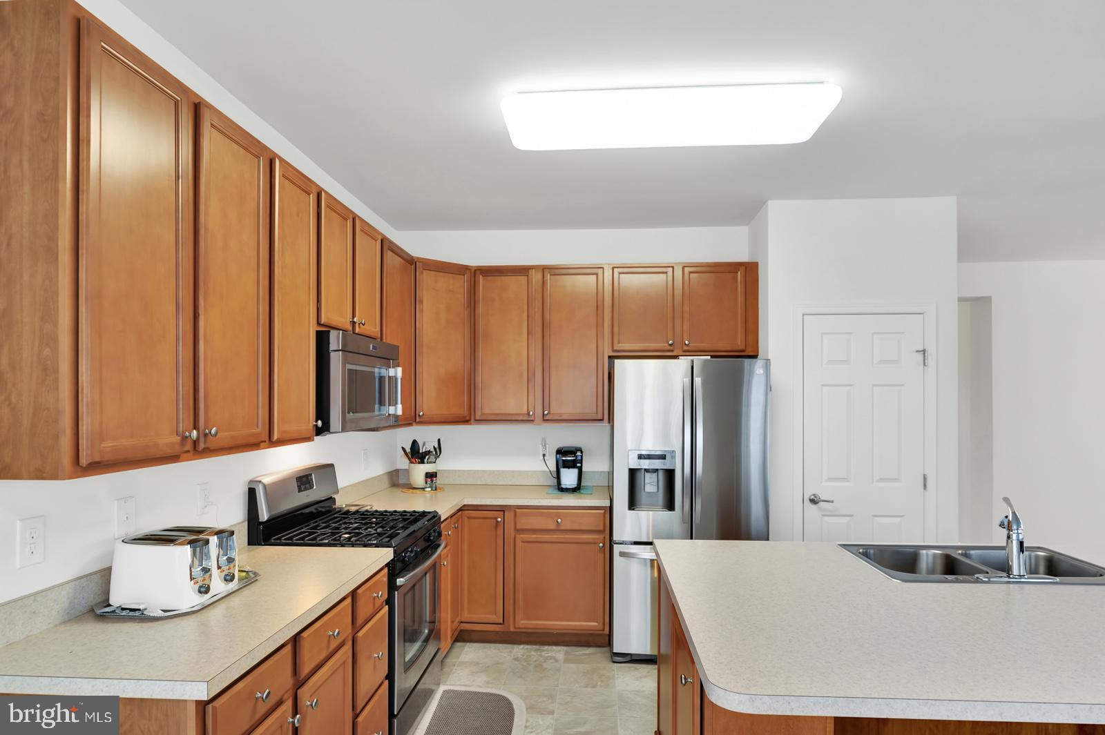 37 Spring Arbor Drive Middletown, DE 19709 - Photo 13 of 37 a kitchen with a sink refrigerator and cabinets