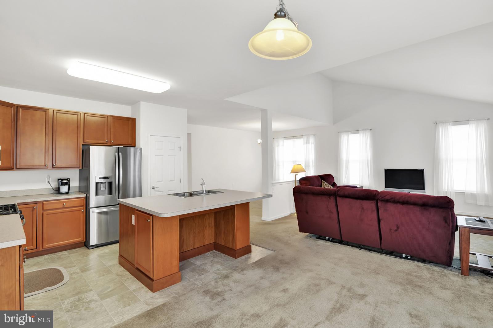 37 Spring Arbor Drive Middletown, DE 19709 - Photo 16 of 37 a living room with stainless steel appliances kitchen island granite countertop a sink dishwasher stove and refrigerator with wooden floor