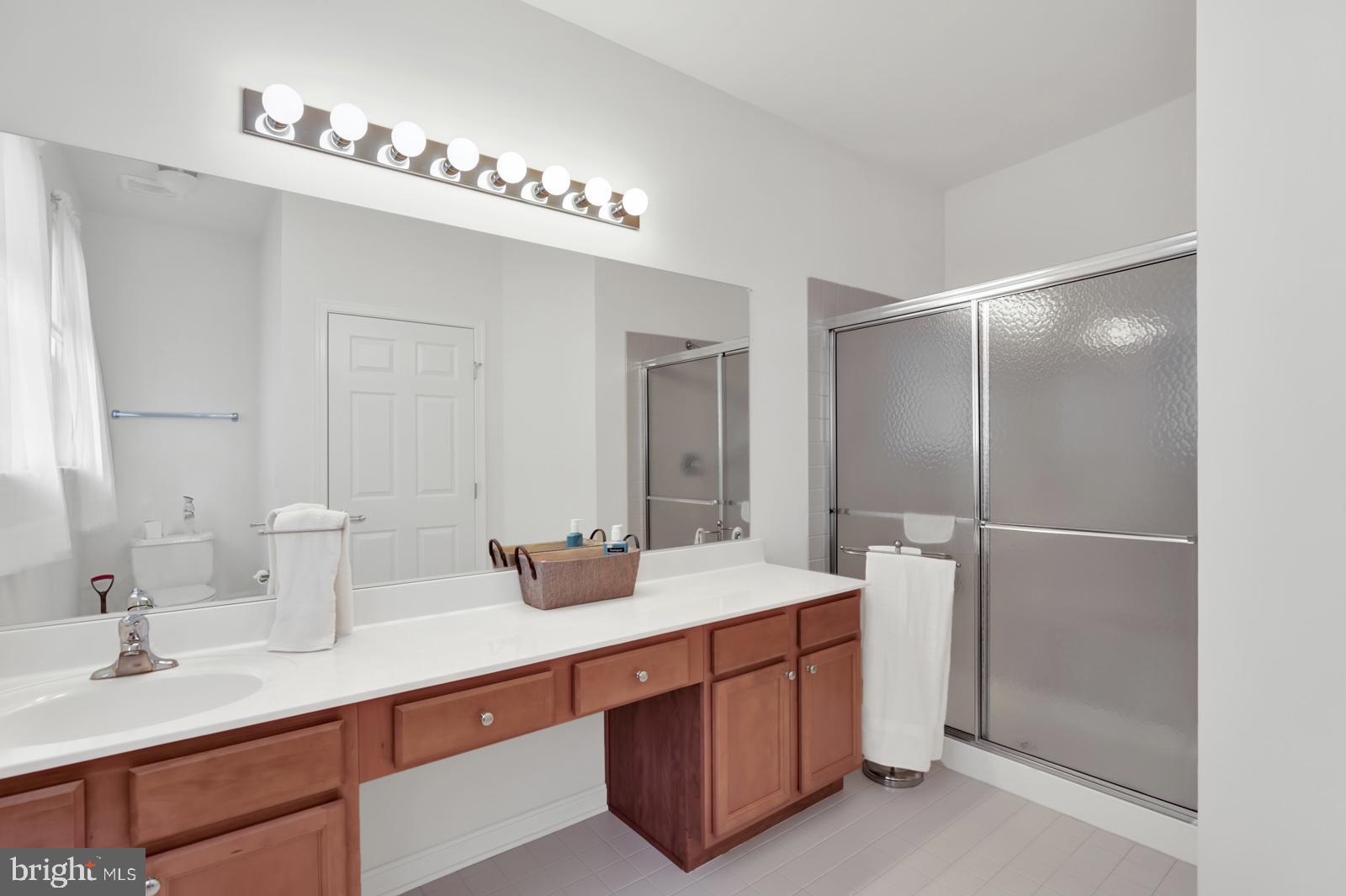 37 Spring Arbor Drive Middletown, DE 19709 - Photo 21 of 37 a bathroom with double vanity sinks a vanity a lamp and a mirror