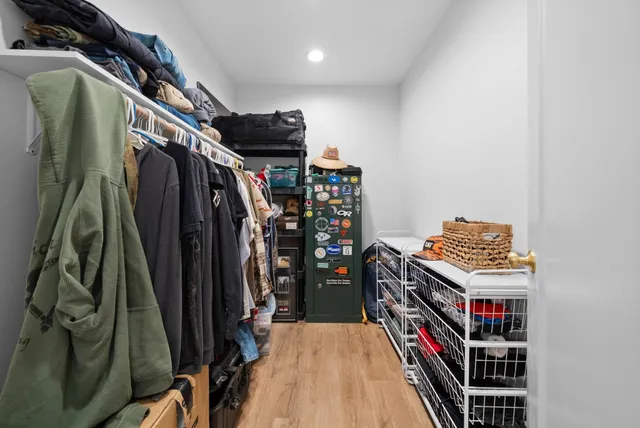 a view of walk in closet with clothes and shoes