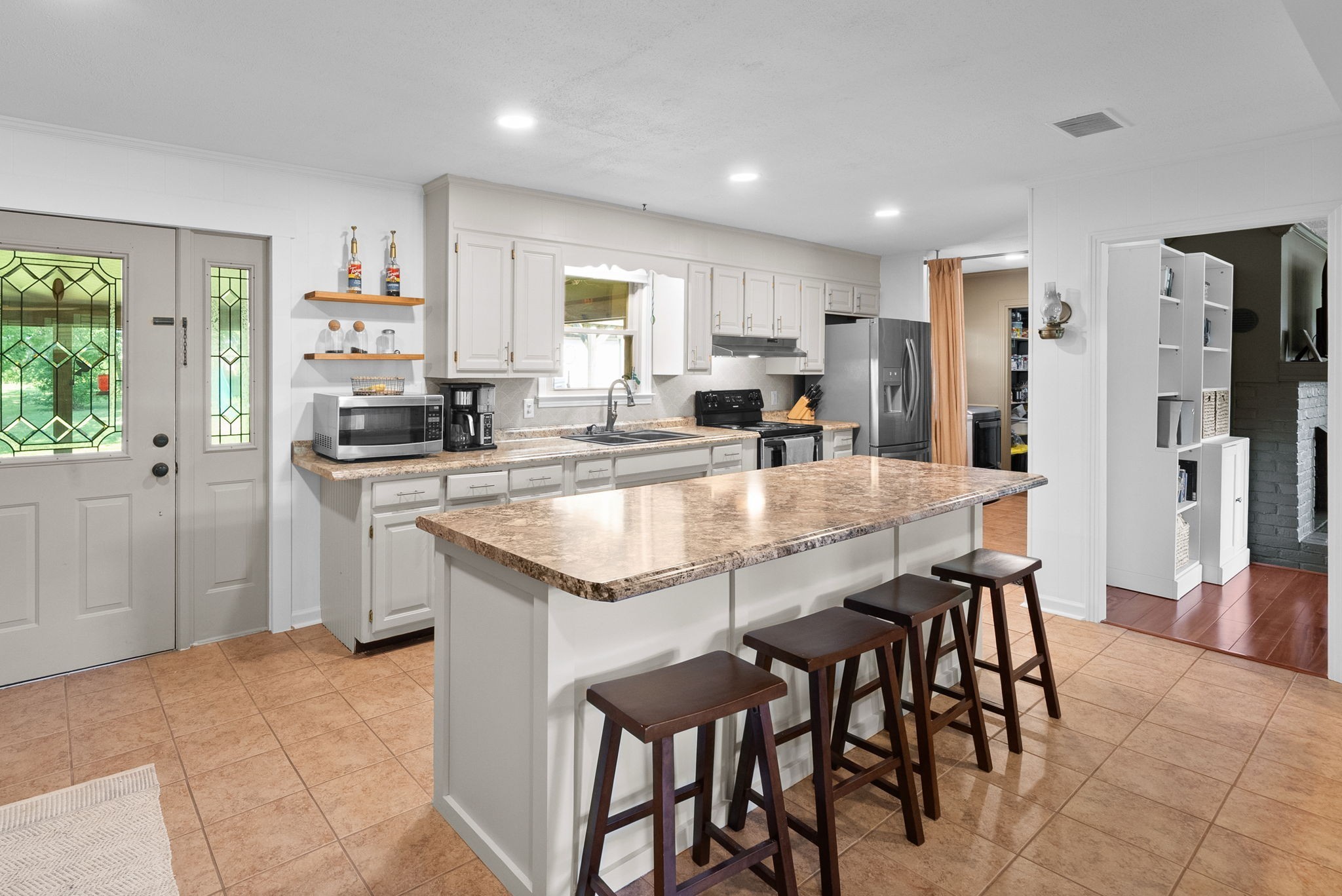 3680 Zentmyer Road Crofton, KY 42217 - Photo 10 of 43 a kitchen with stainless steel appliances granite countertop a table chairs sink refrigerator and cabinets