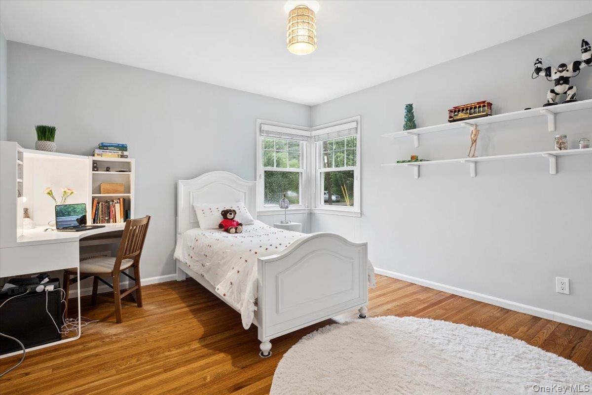 30 Stonehouse Road Scarsdale, NY 10583 - Photo 14 of 24 Light-filled room featuring wood flooring and two exposures.