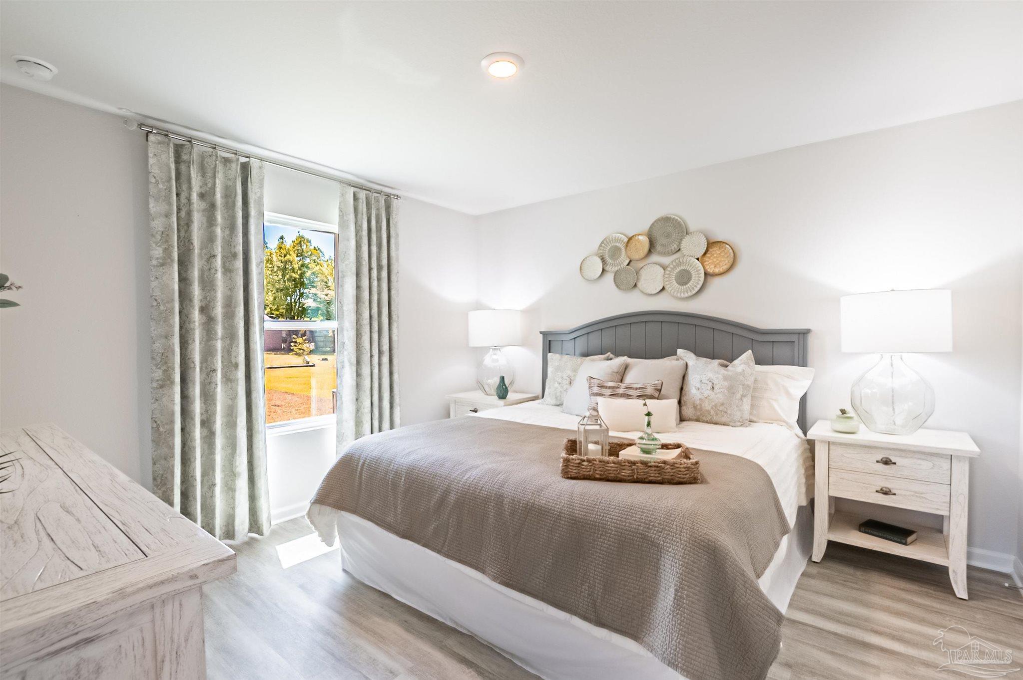 6274 June Bug Drive Milton, FL 32583 - Photo 12 of 17 a bedroom with a bed and a window