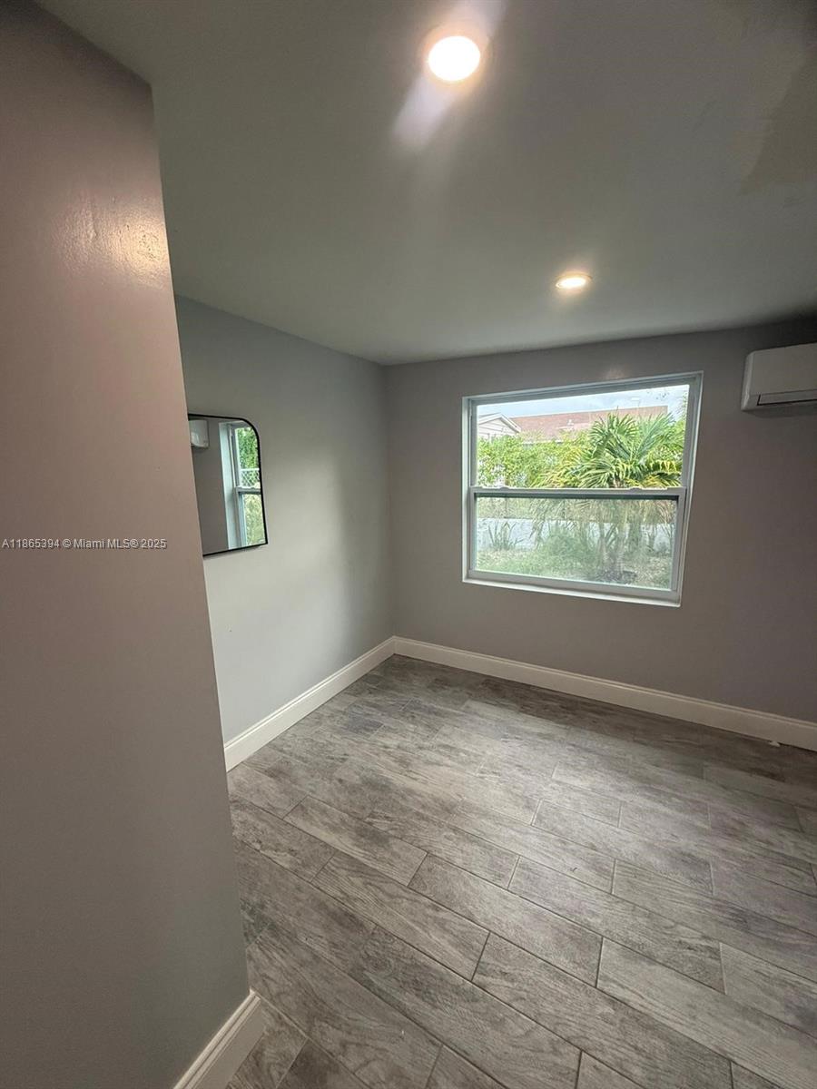 173 West 16th Street, Unit A Riviera Beach, FL 33404 - Photo 12 of 17 an empty room with windows