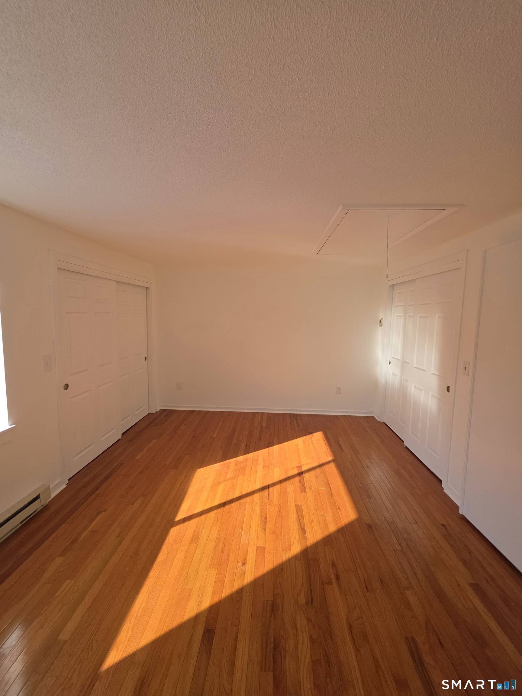 51 Brook Street, Unit 6A Naugatuck, CT 06770 - Photo 23 of 32 a view of empty room with wooden floor
