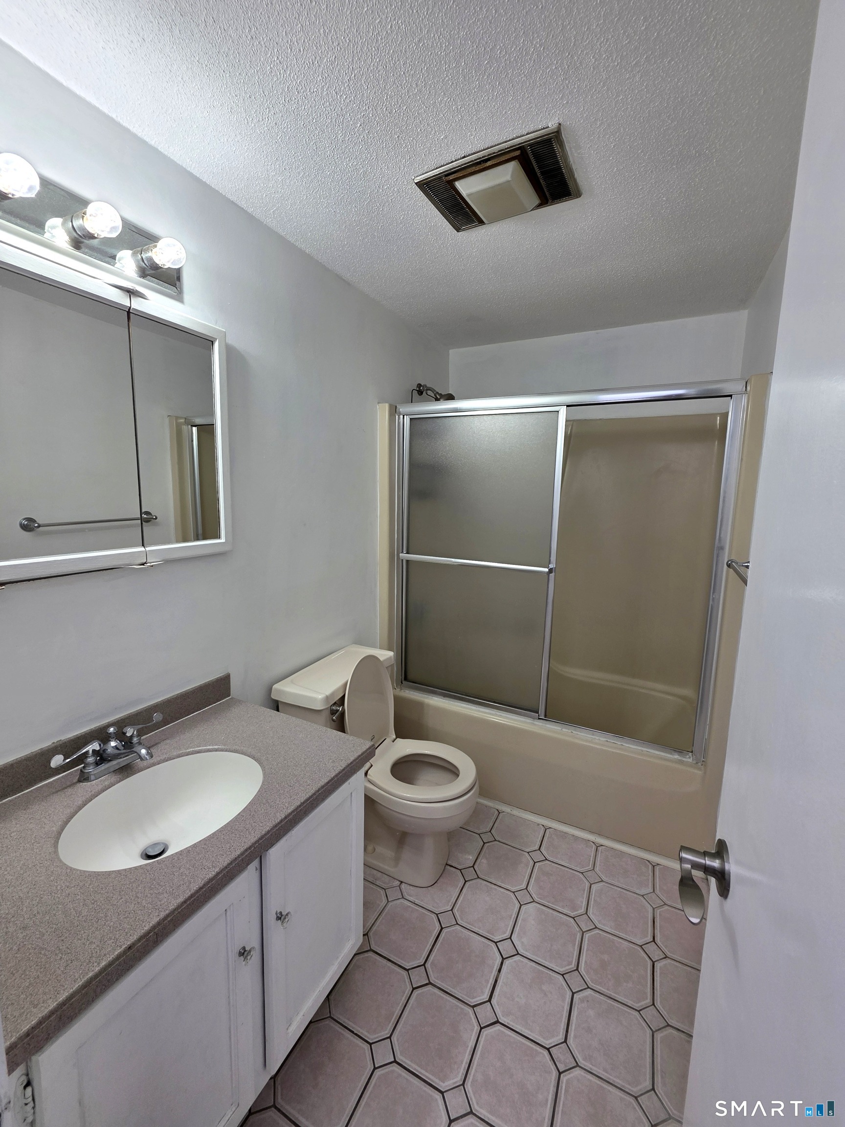 51 Brook Street, Unit 6A Naugatuck, CT 06770 - Photo 27 of 32 a bathroom with a sink a toilet and shower