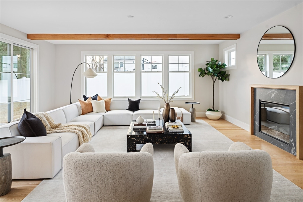 5 Hazel Lane Needham, MA 02494 - Photo 12 of 39 a living room with furniture a large window and a fireplace