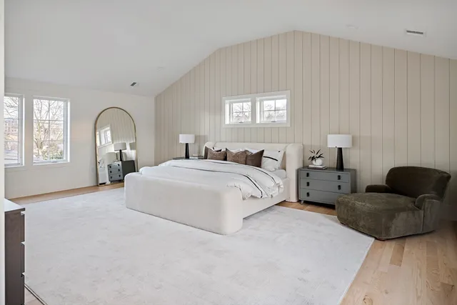 a spacious bedroom with a bed and window