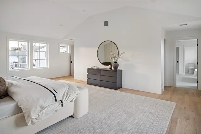 a bedroom with a bed and a dresser