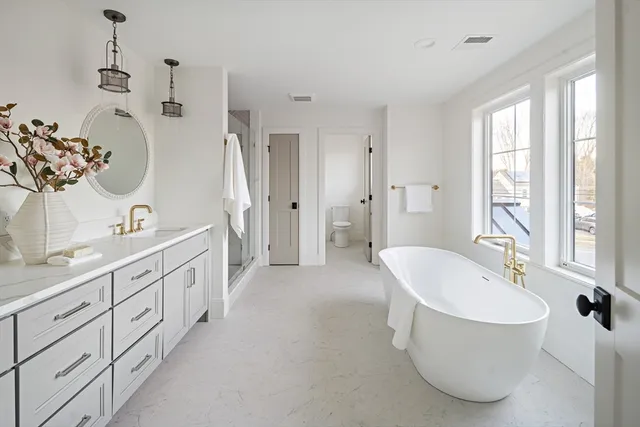 a spacious bathroom with a double vanity sink mirror and double