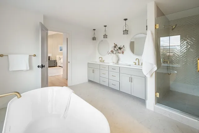 a spacious bedroom with a bed and a mirror