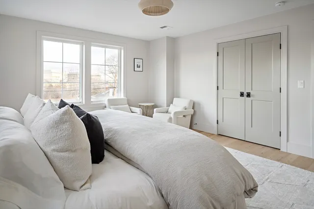 a bed room with a bed and a large window