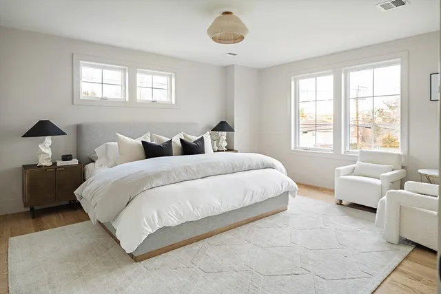 a bedroom with bed couch and window