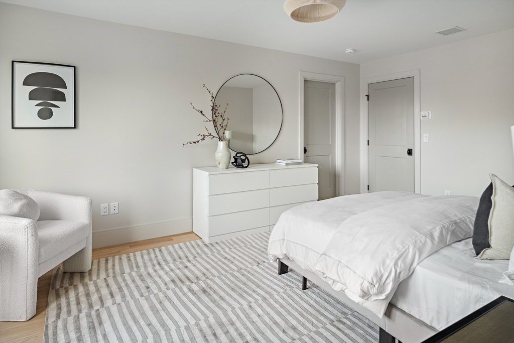 5 Hazel Lane Needham, MA 02494 - Photo 22 of 39 a bedroom with a bed and a chair