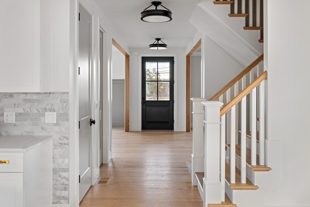 5 Hazel Lane Needham, MA 02494 - Photo 32 of 39 a view of a hallway with wooden floor and staircase