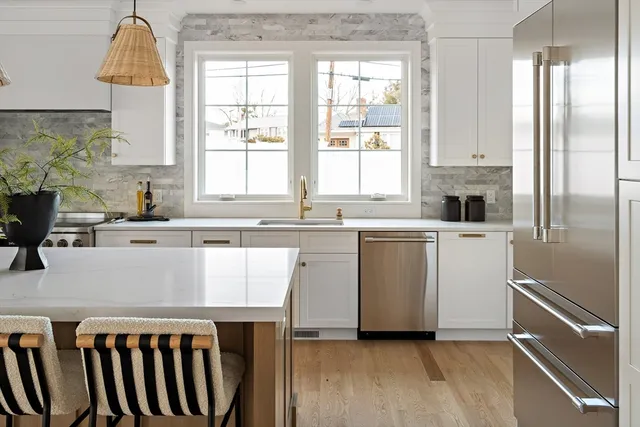 a kitchen with a sink a window and cabinets