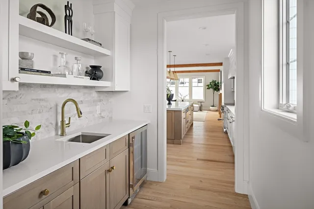 a view of a kitchen cabinets a sink and wooden floor