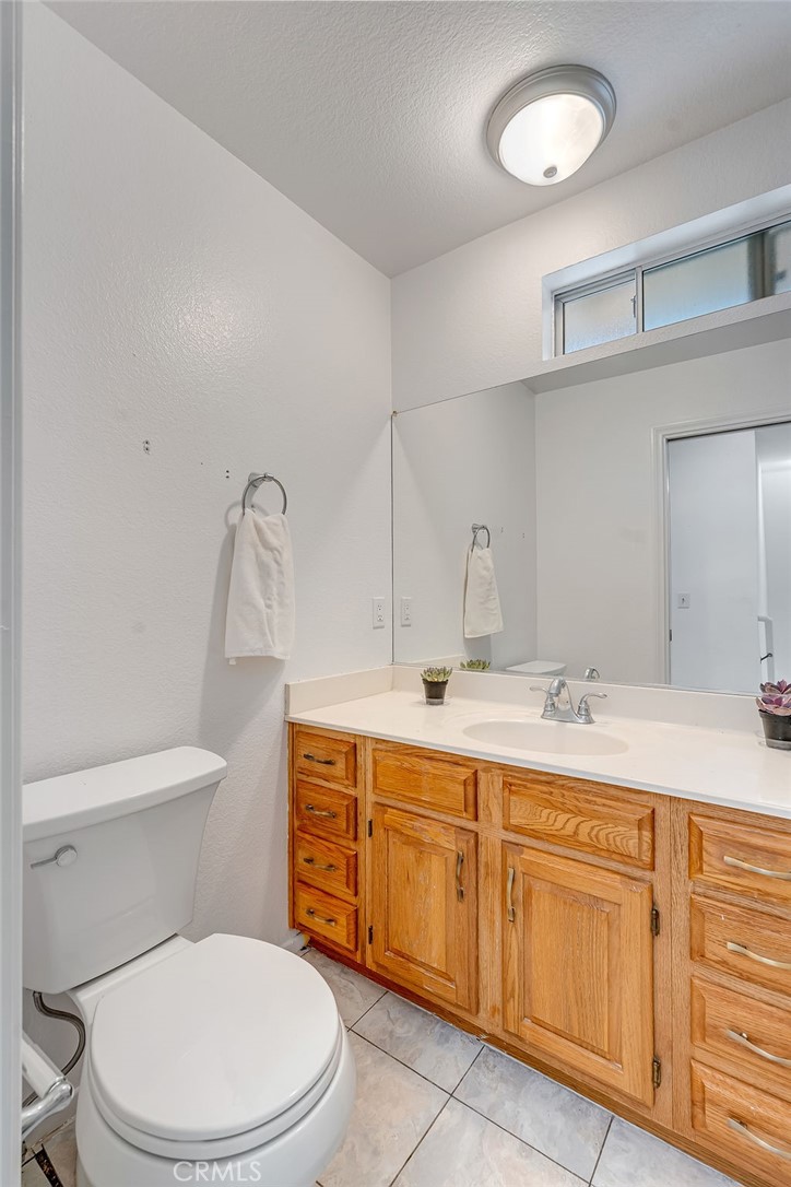 318 Old Toll Road Lake Arrowhead, CA 92352 - Photo 18 of 44 a bathroom with a toilet a sink and mirror