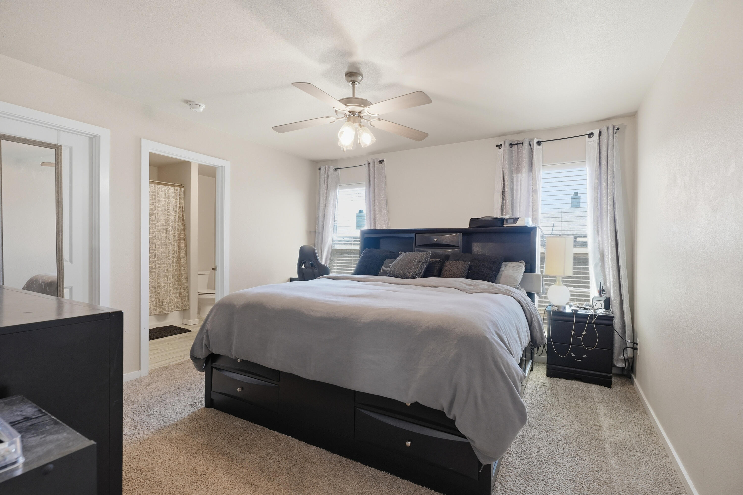 1919 140th Street Lubbock, TX 79423 - Photo 13 of 23 a bedroom with a bed and a chandelier