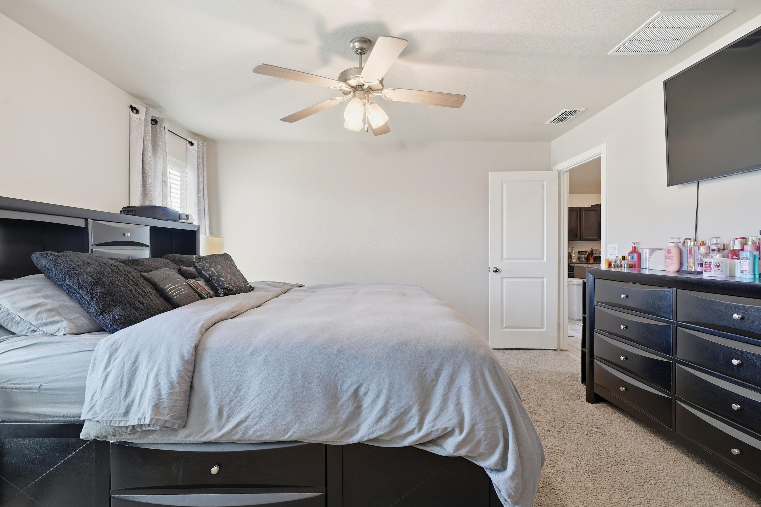 1919 140th Street Lubbock, TX 79423 - Photo 14 of 23 a bedroom with a bed and a flat screen tv