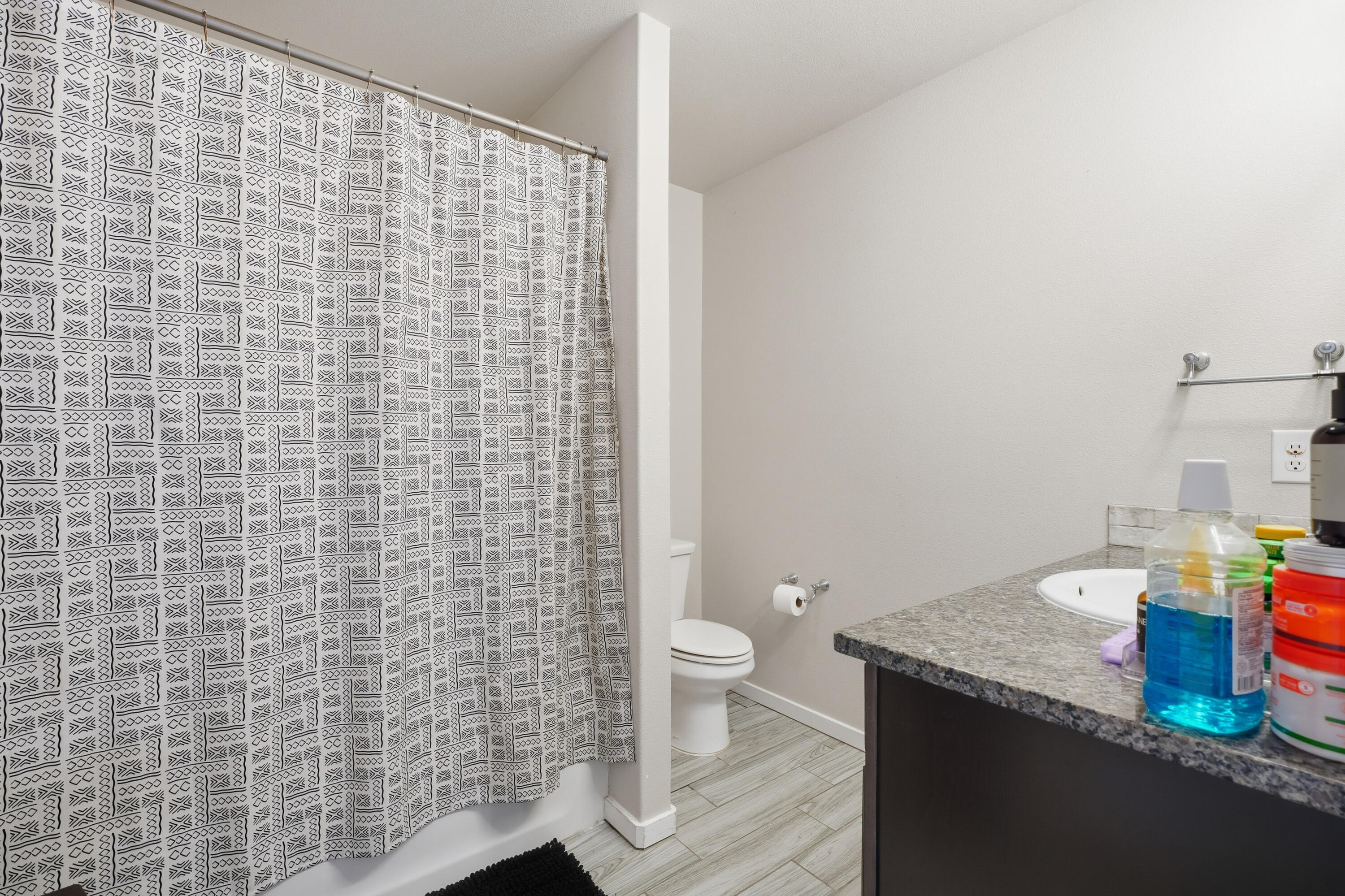 1919 140th Street Lubbock, TX 79423 - Photo 15 of 23 a bathroom with a granite countertop toilet and a sink