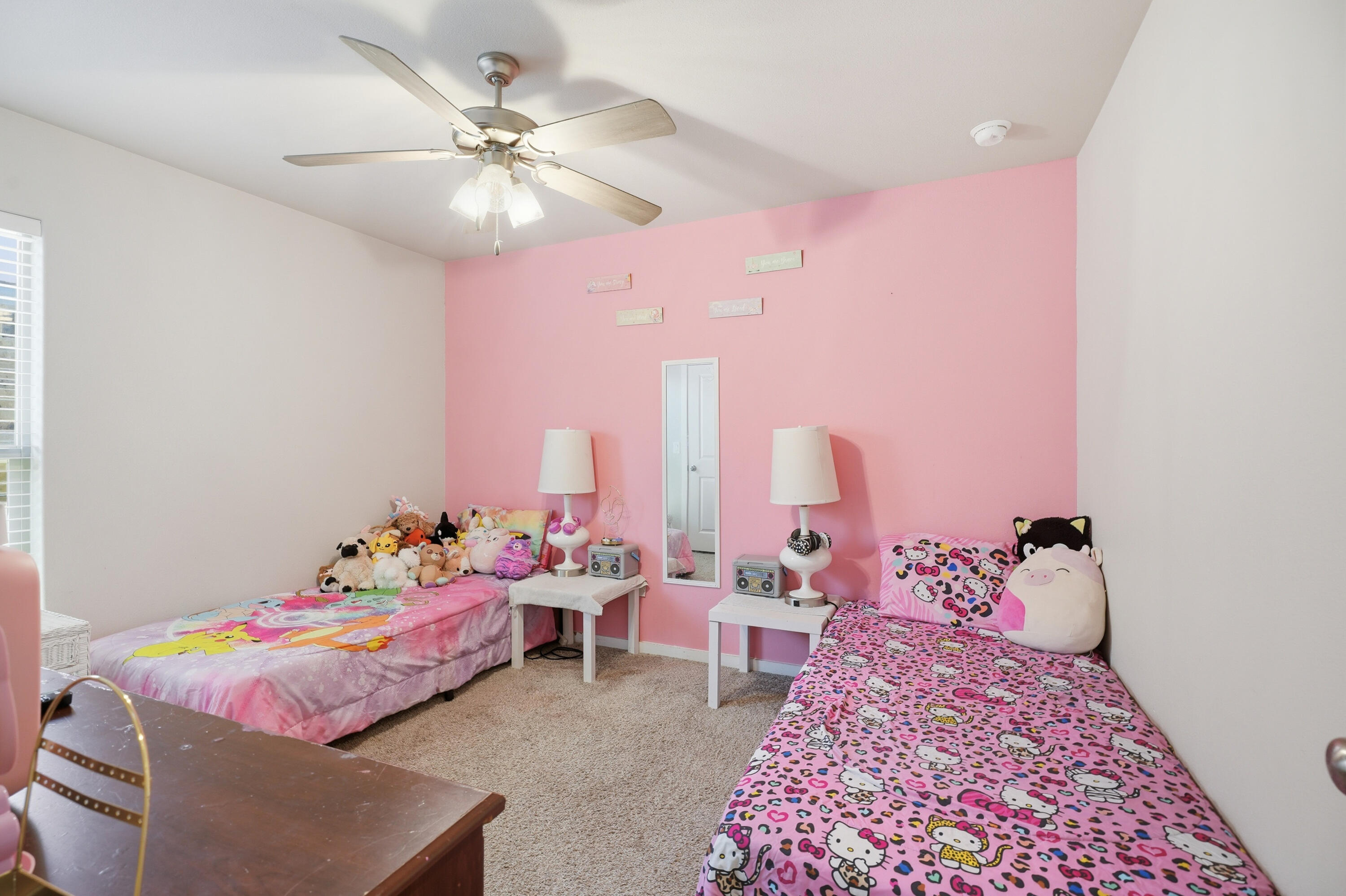 1919 140th Street Lubbock, TX 79423 - Photo 19 of 23 a bedroom with a bed and a chandelier