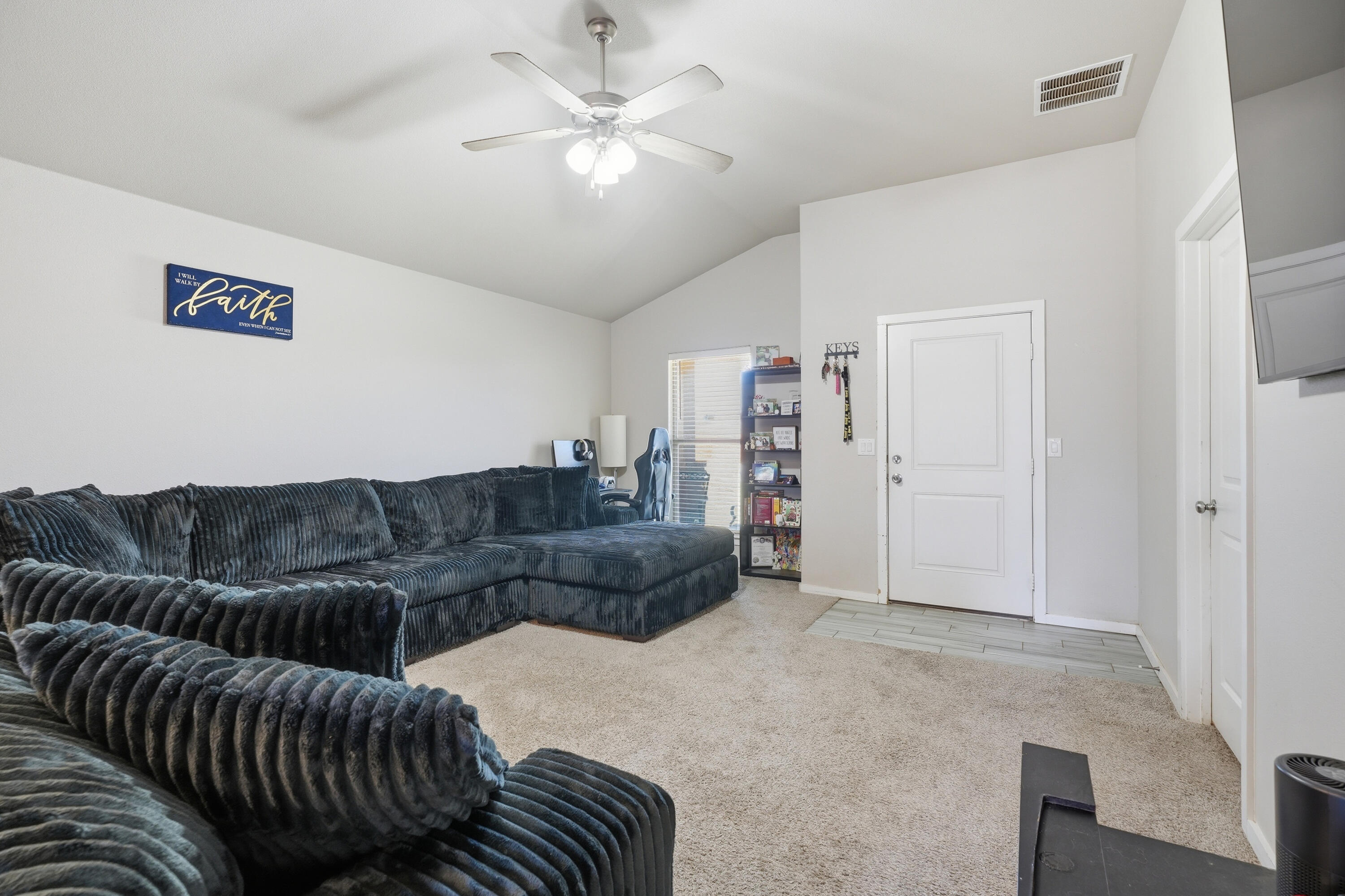 1919 140th Street Lubbock, TX 79423 - Photo 6 of 23 a living room with furniture and a chandelier