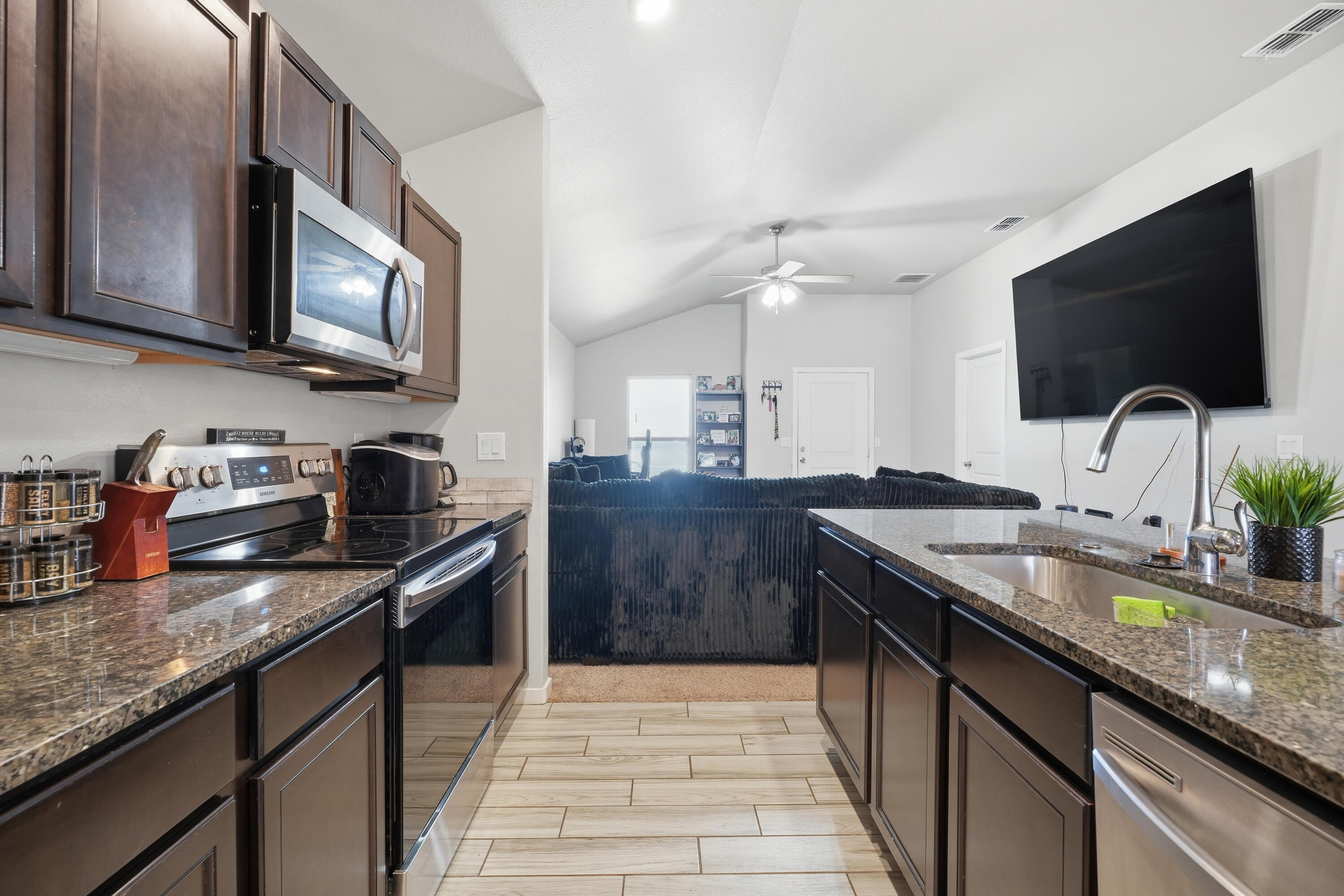 1919 140th Street Lubbock, TX 79423 - Photo 8 of 23 a kitchen with stainless steel appliances granite countertop a sink and a stove