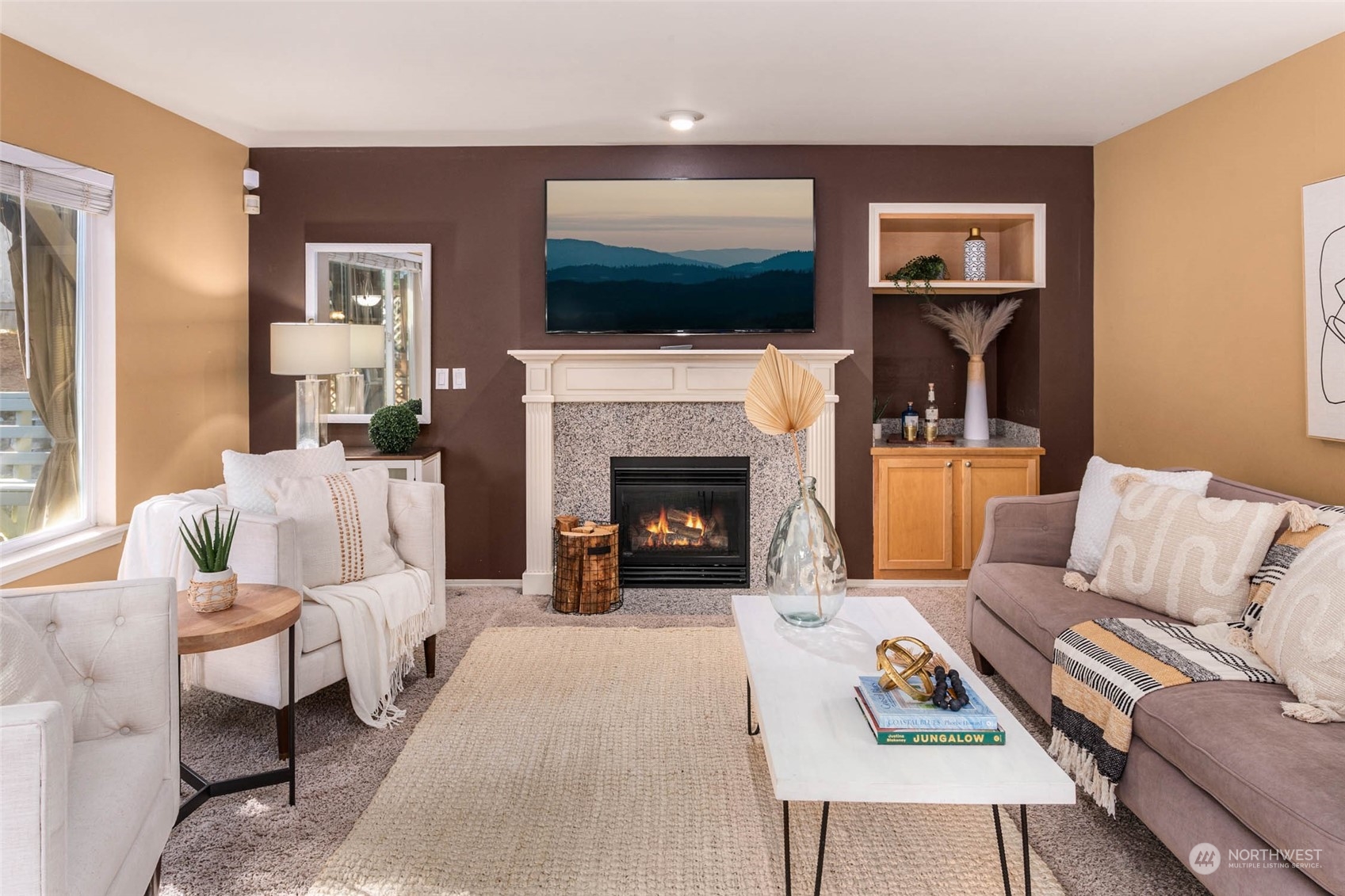 2710 236th Street Southeast Bothell, WA 98021 - Photo 12 of 30 a living room with furniture a flat screen tv and a fireplace