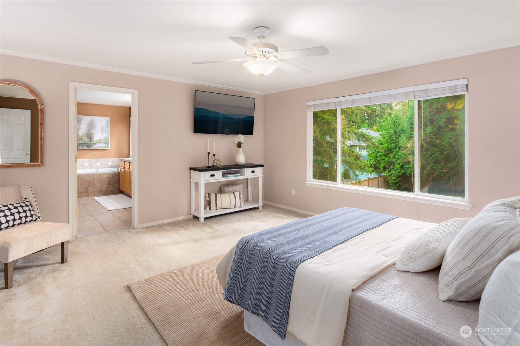 2710 236th Street Southeast Bothell, WA 98021 - Photo 18 of 30 a spacious bedroom with a bed and a flat screen tv