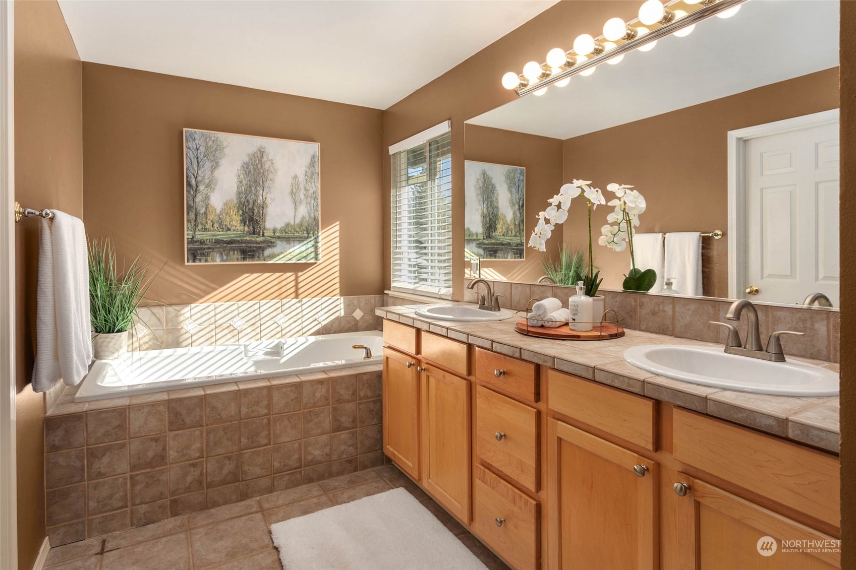 2710 236th Street Southeast Bothell, WA 98021 - Photo 19 of 30 a spacious bathroom with a granite countertop sink a large mirror and a bathtub