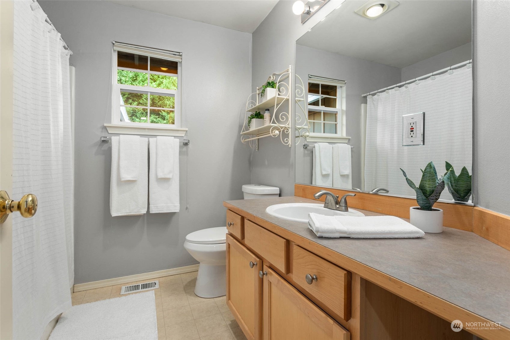 2710 236th Street Southeast Bothell, WA 98021 - Photo 22 of 30 a bathroom with a sink a toilet and a mirror