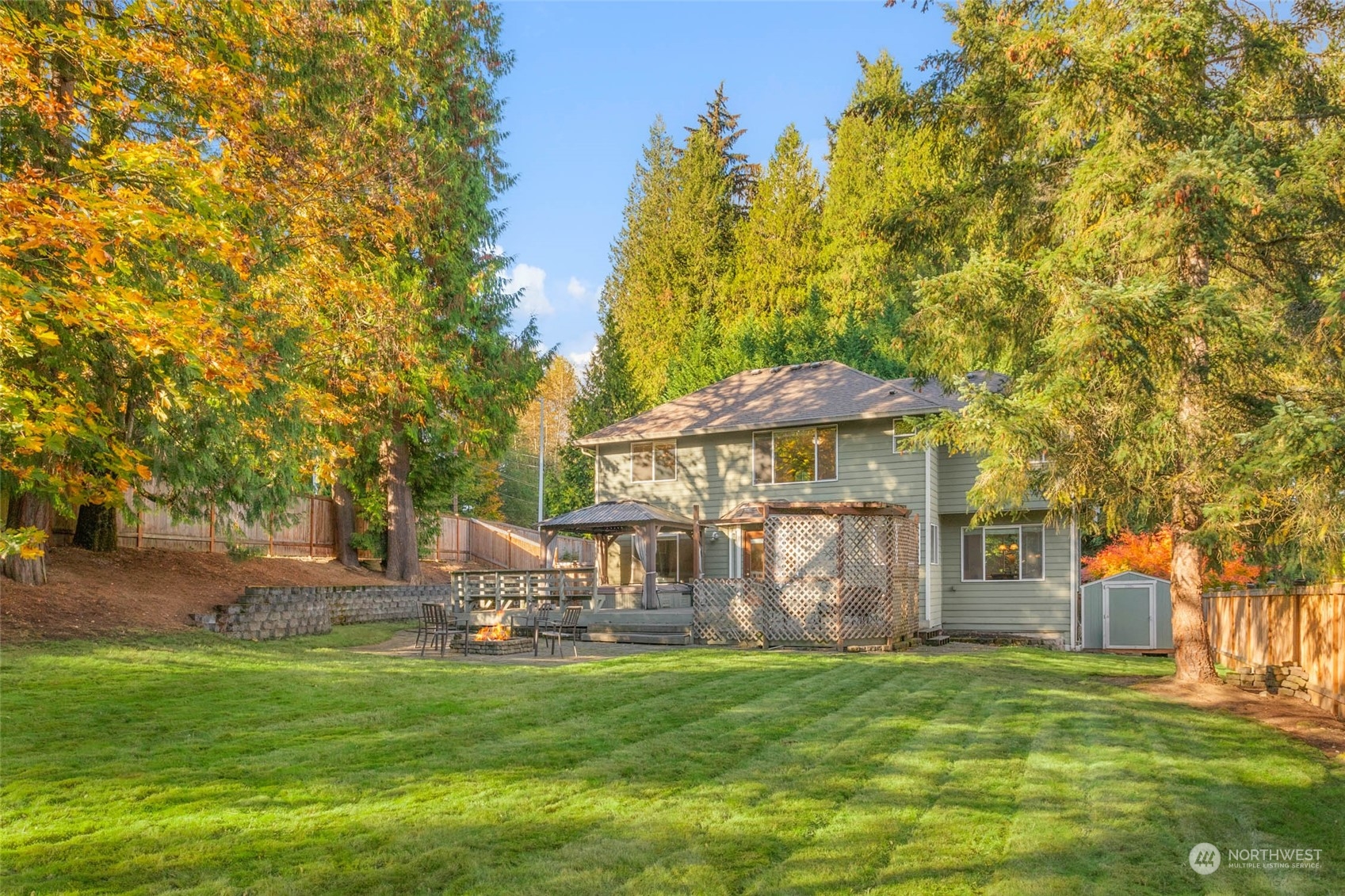 2710 236th Street Southeast Bothell, WA 98021 - Photo 26 of 30 a backyard of a house with table and chairs