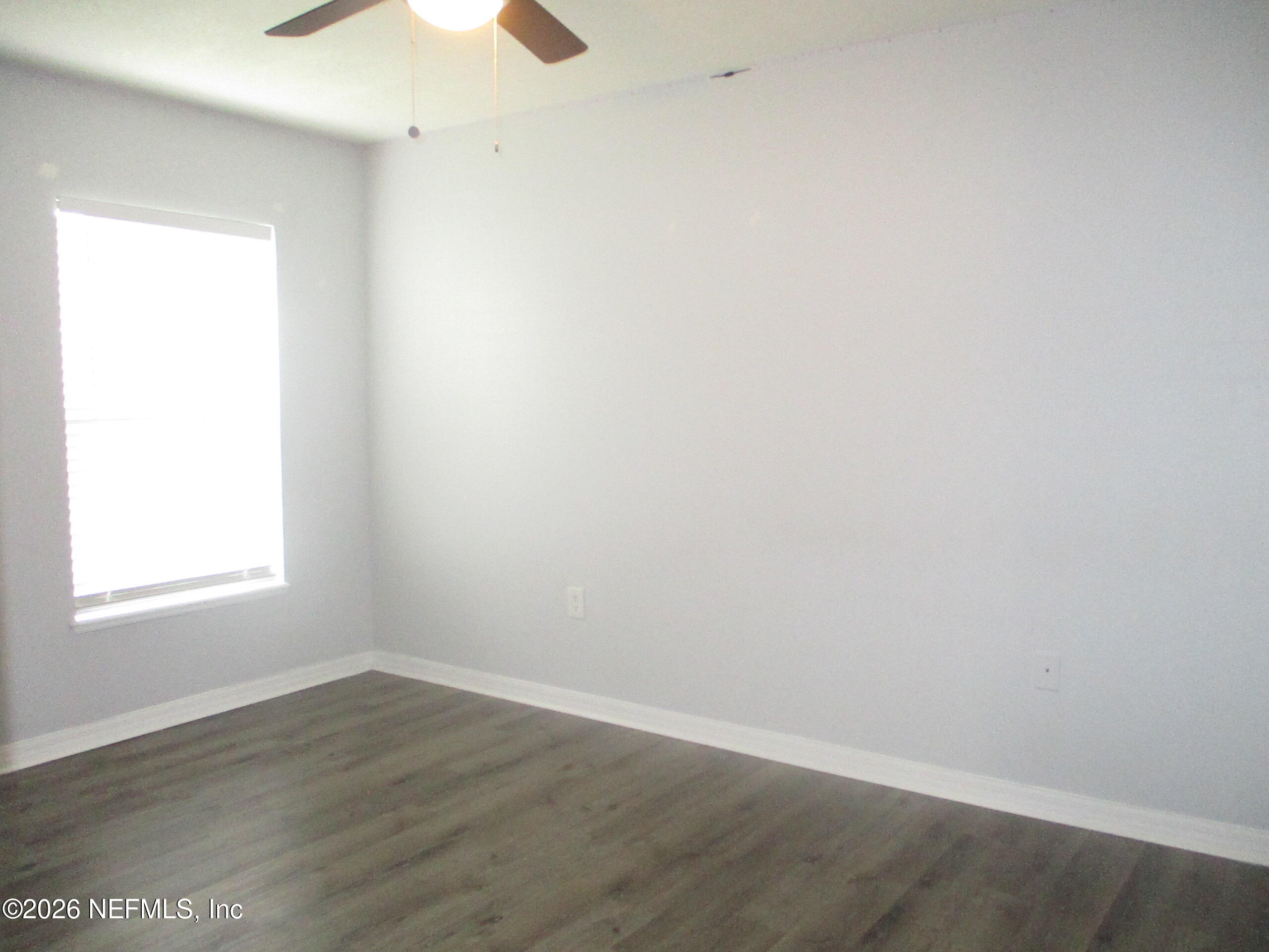 738 North 5th Street Macclenny, FL 32063 - Photo 4 of 23 an empty room with wooden floor and window