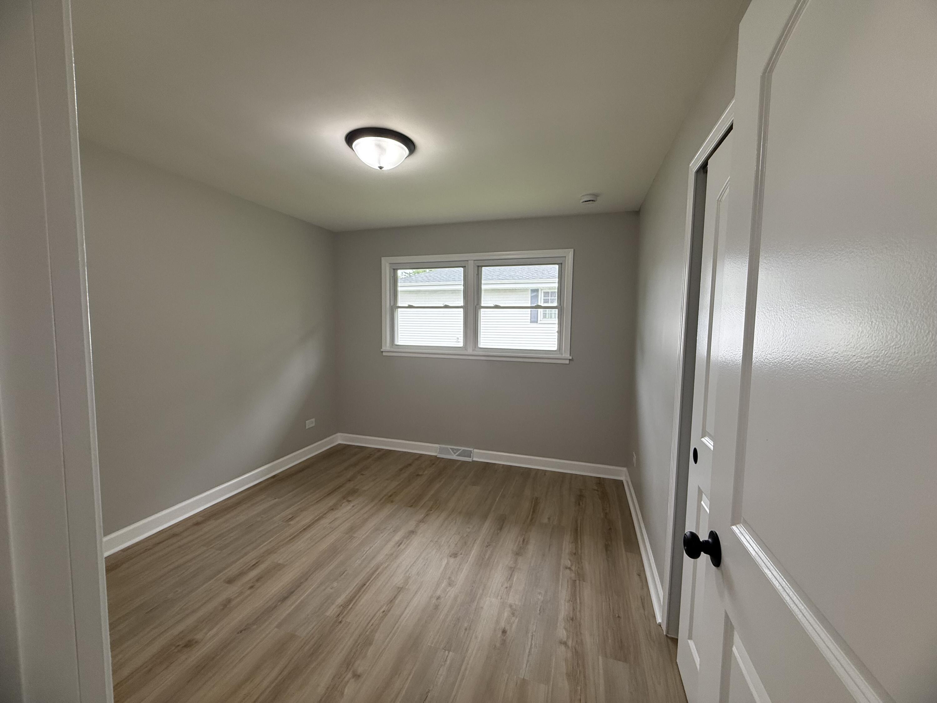 408 Cherry Hill Road Dyer, IN 46311 - Photo 15 of 31 an empty room with wooden floor and windows