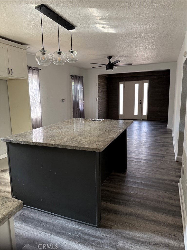 242 East M Street Colton, CA 92324 - Photo 11 of 19 a kitchen with kitchen island stainless steel appliances a sink window and wooden floor
