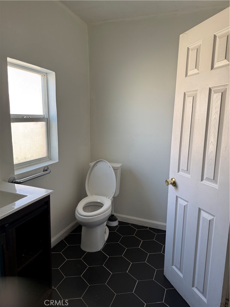 242 East M Street Colton, CA 92324 - Photo 13 of 19 a bathroom with a sink toilet and window